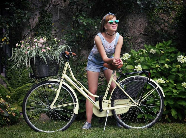 girl standing beside a bicycle with gps tracker installed in the cycle 1024x758 1